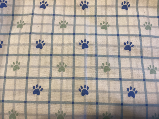 Soft blue and sage paw prints on blue and white plaid 