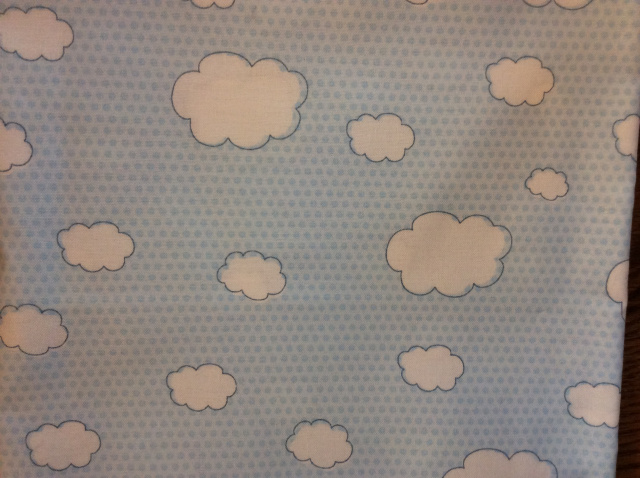Fluffy white clouds on soft blue dots