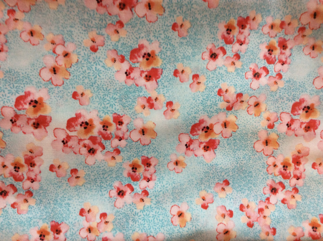 Coral flowers over a tiny aqua daisy print