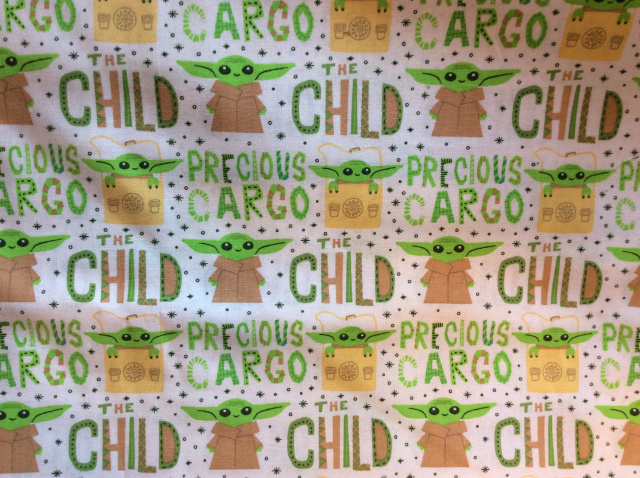 The child is green with large ears and words say Precious Cargo and The Child on white