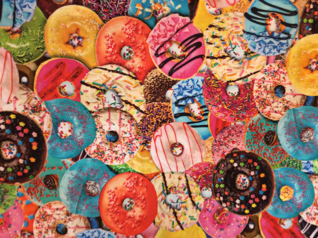 Donuts in all flavors and colors with sprinkles and icing 