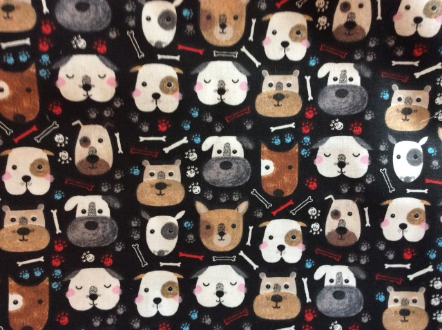 Assorted dog faces on black with paw prints and bones