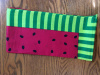 Red interior with black watermelons seeds with a border of lime/green stripes